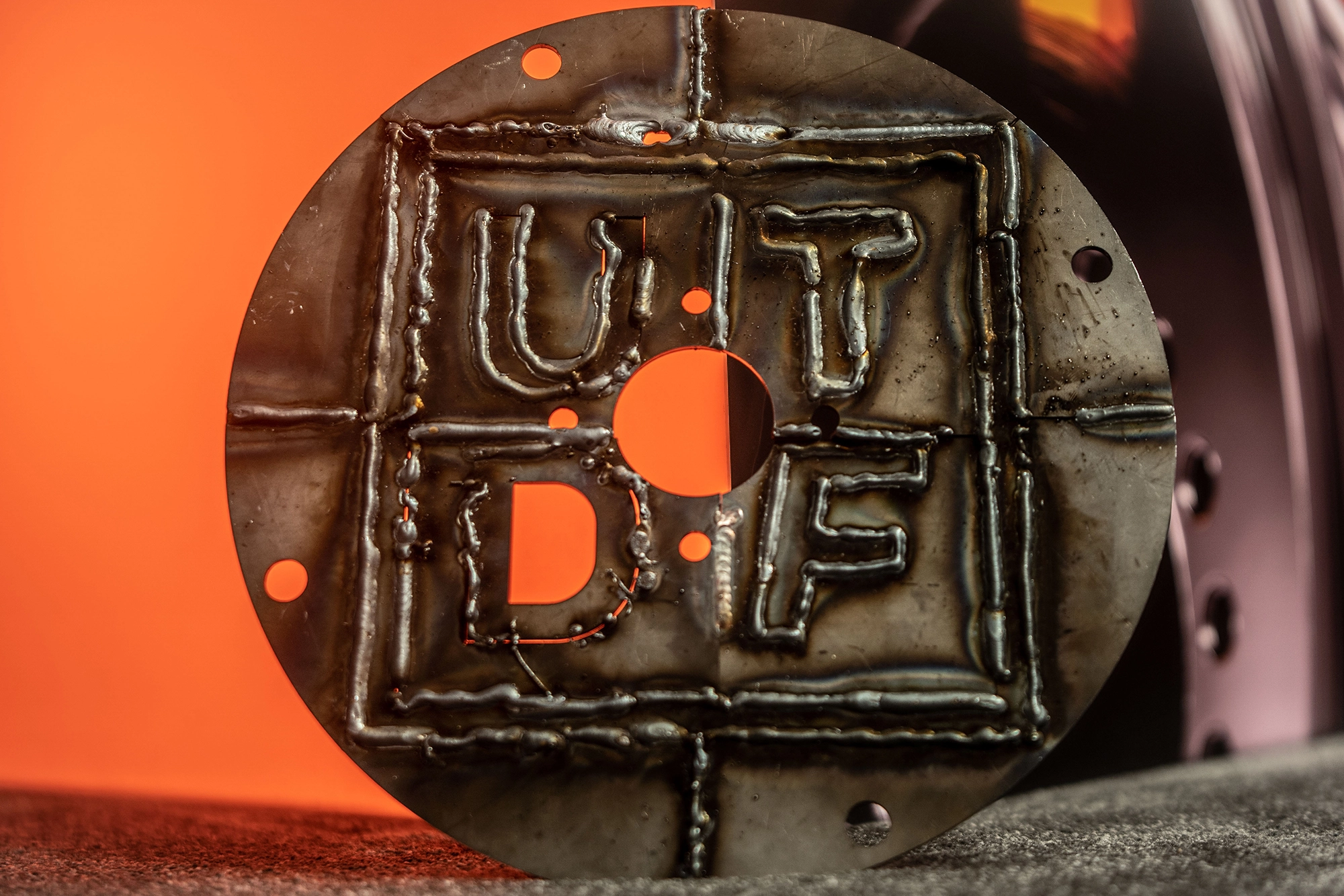 Disc with the Up To Date Festival logo welded at the event